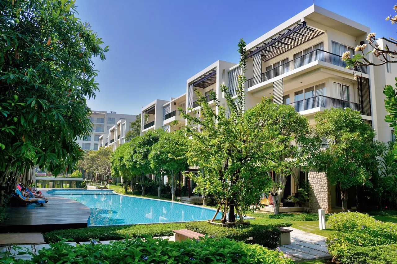Condomínio residencial com piscina e jardim arborizado